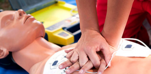 closeup of hands performing CPR on a dummy