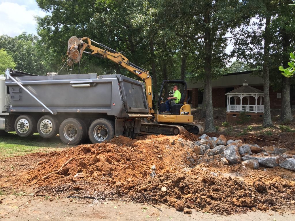 Dump truck removing old amphitheater.