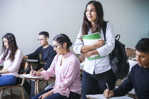 Student in class with classmates holding books