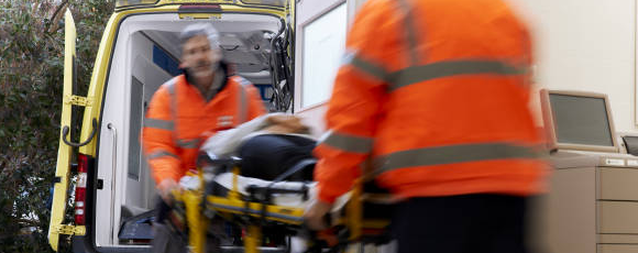 Men loading stretcher into ambulance