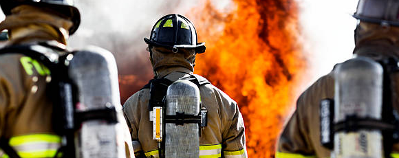 Group of firefighters in front of fire